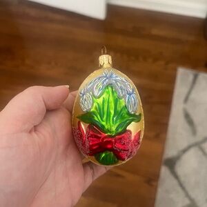 Gold Glass Holiday Ornament with Green Leaves and Red Bow